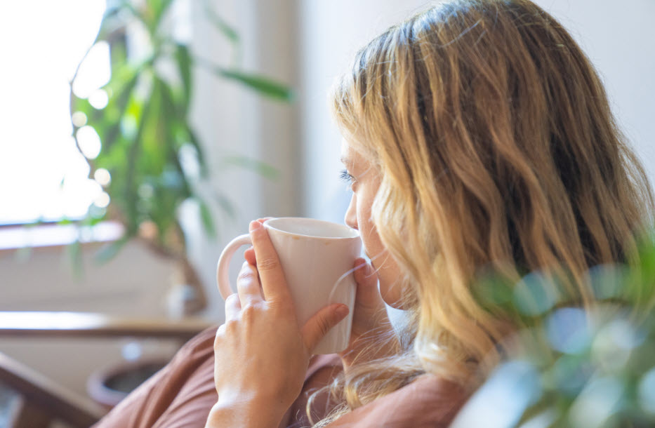 A woman having a peaceful mindful moment detached from chaos and overwhelm.