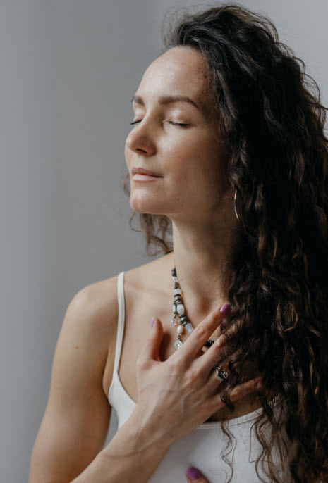 A woman practicing mindfulness in a tranquil space, cultivating self-awareness.