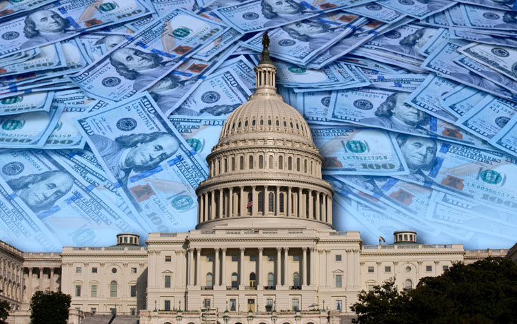 The Capitol building in the forefront. In the background, $100 bills are scattered atop a flat surface. Depicting the illusion of virtue in high places.