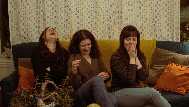 Three women sitting on a couch, each having a different reaction from the other. It's our spirit that makes us human each one with a different drive, purpose and depth in how they live their lives.