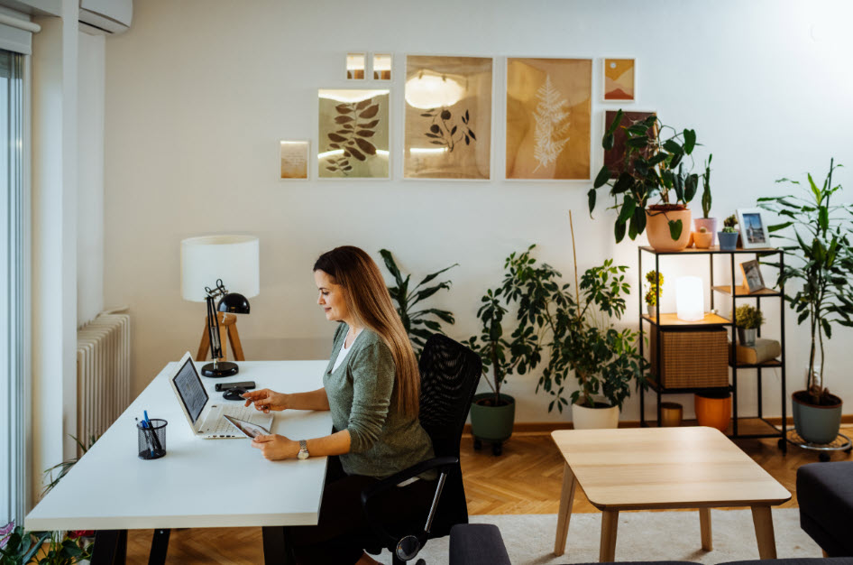 A woman in her work space is at peace and in harmony with her work-life environment.