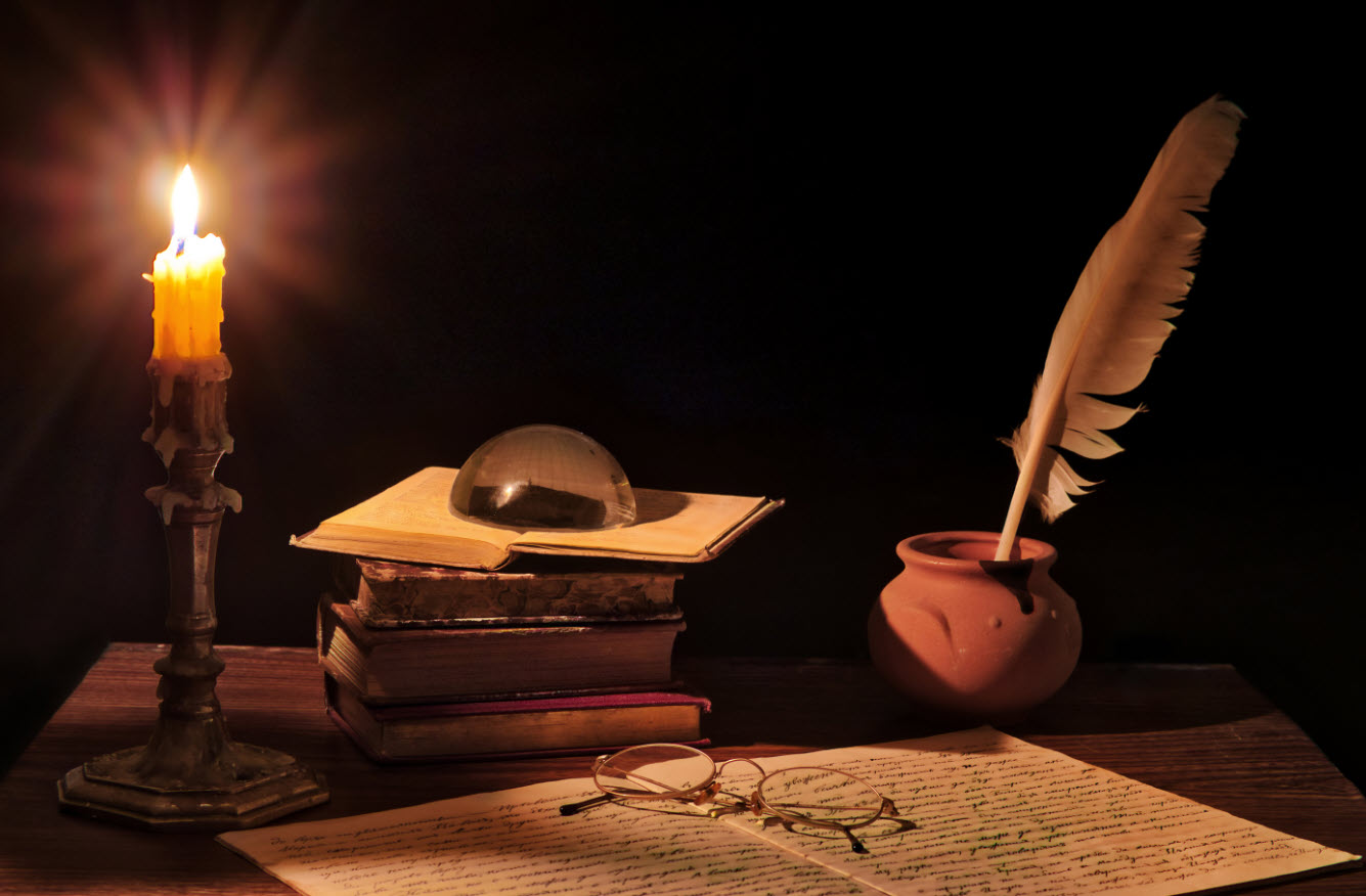A wooden desk with a candlestick with a lit candle, stack of books, a glass paper weight, and a jar with a feather pen line the outer edge of the small desk. Two sheets of paper with writing and a pair of glasses weighing down the sheets of paper. With all the chaos, will someone fix what's broken?