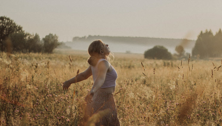 A woman walking barefoot symbolizing soul-aligned freedom.
